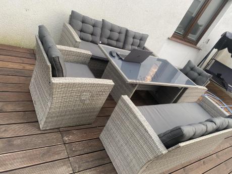 Meble ogrodowe z dwoma kanapami i stołem obiadowym