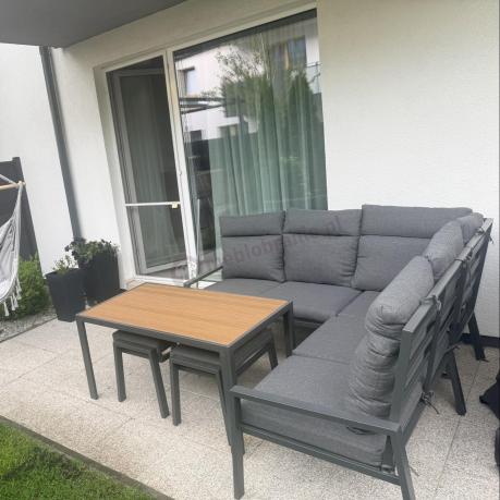 Metalowy narożnik na taras z pufami i stołem 120cm Doros Corner - Polywood Dark Grey
