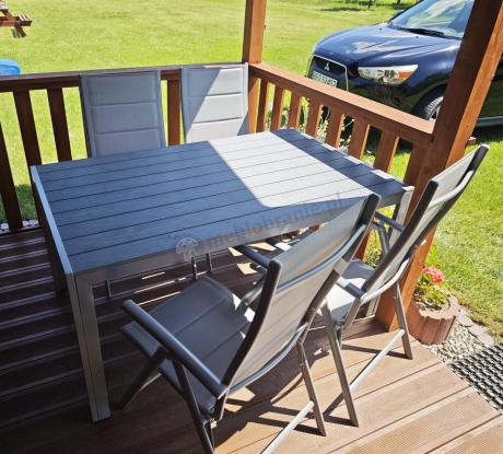 Szary komplet mebli ogrodowych ze stołem obiadowym i składanymi krzesłami - Kanbery Silver 6+1