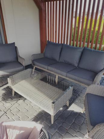 Szary komplet mebli z technorattanu dla 5 osób z sofą i fotelami Cioso