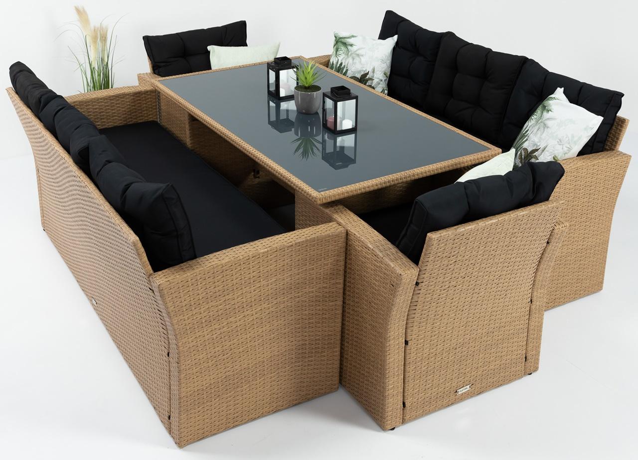 meble ogrodowe z czarnymi poduszkami wsunięte pod stół