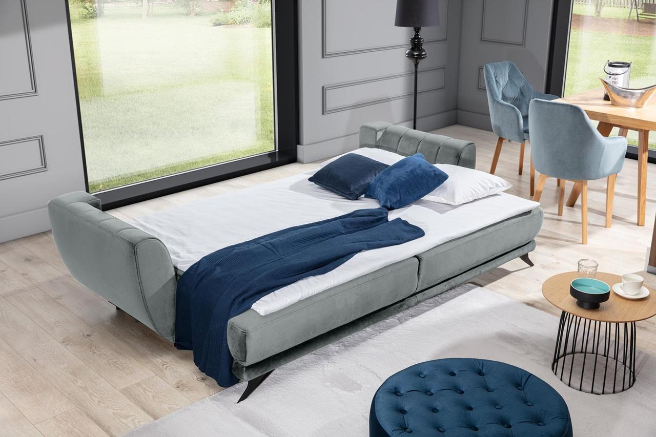 rozłożona szara sofa w salonie