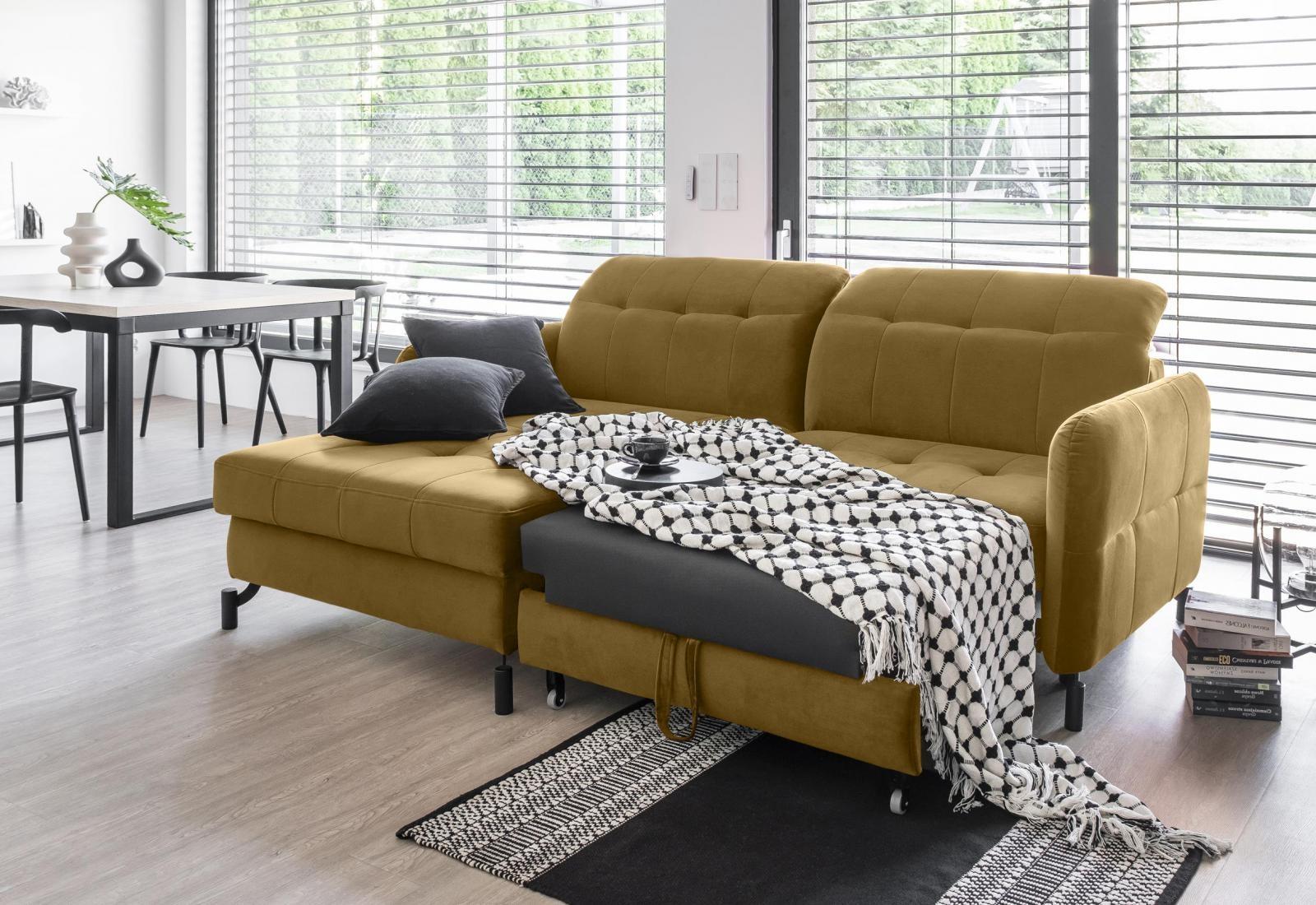 żółta kanapa pikowana rozłożona